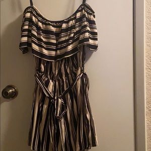 small striped romper has a bow that can be removed